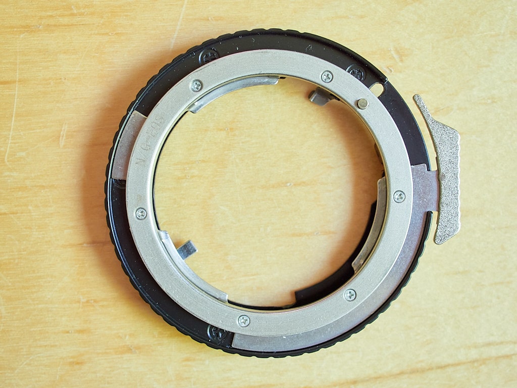 Nikon G / Canon EF adapter already shimmed. Objective-side “Nikon G camera mount” of the adapter. Shim was installed under upper metal ring after removing the six screws visible in the photograph.