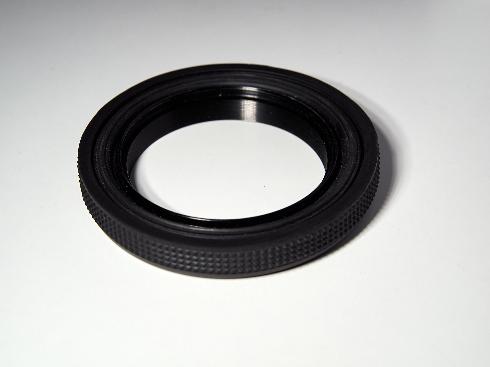 Collapsible rubber lens hood, collapsed.